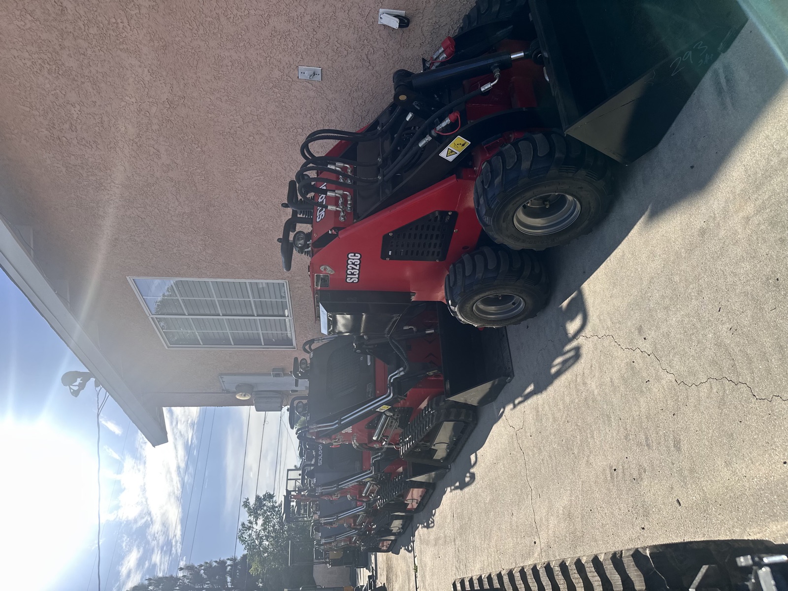 Compact loaders parked beside the workshop
