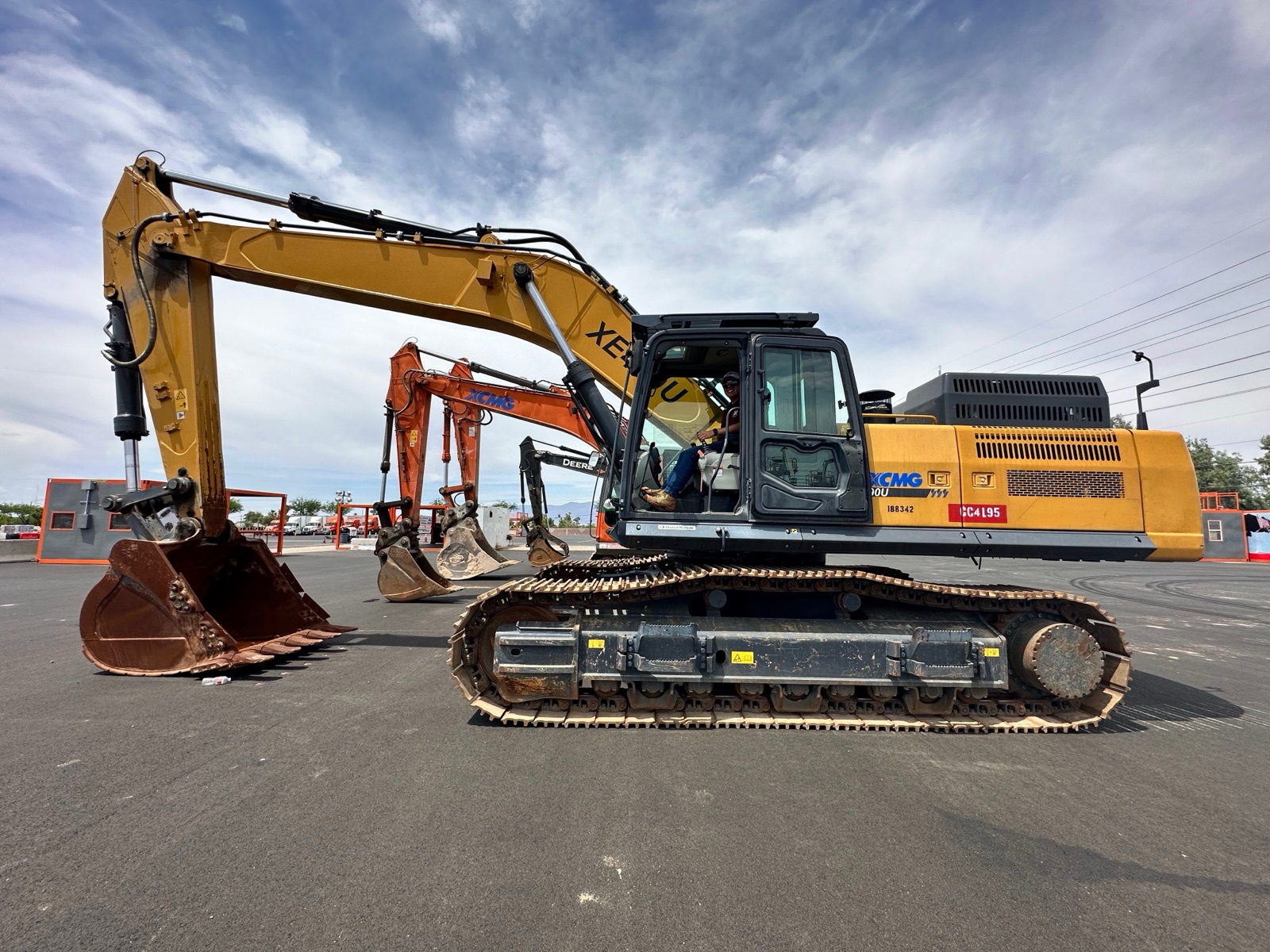 A large excavator parked with other machines