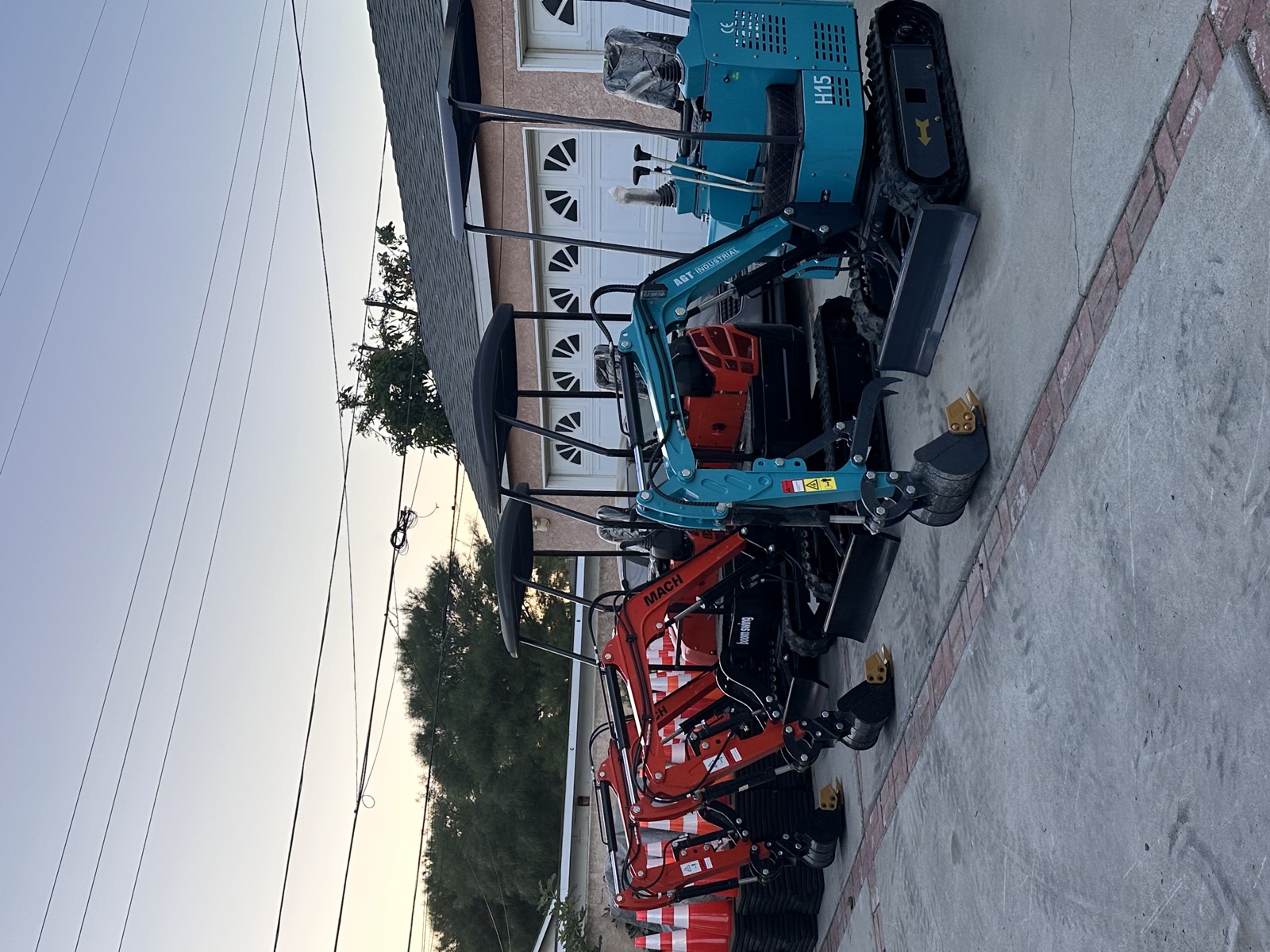 Compact excavators lined up outside the original garage
