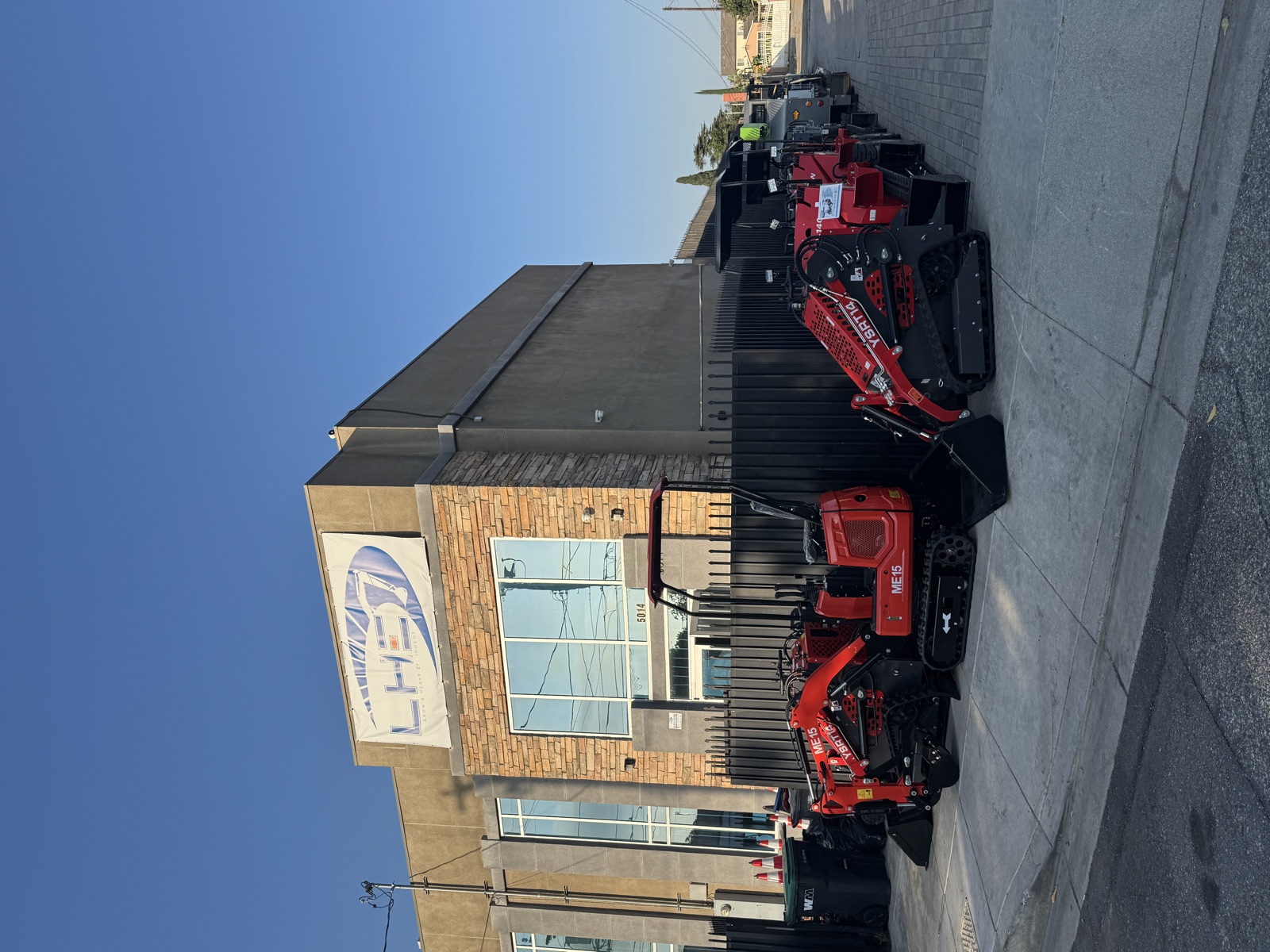 The Baldwin Park shop with a Leon’s Heavy Equipment banner and machines outside